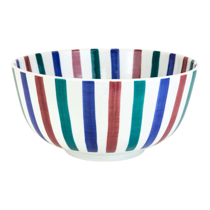 Handmade Moroccan striped serving bowl styled on dining table – artisan tableware
