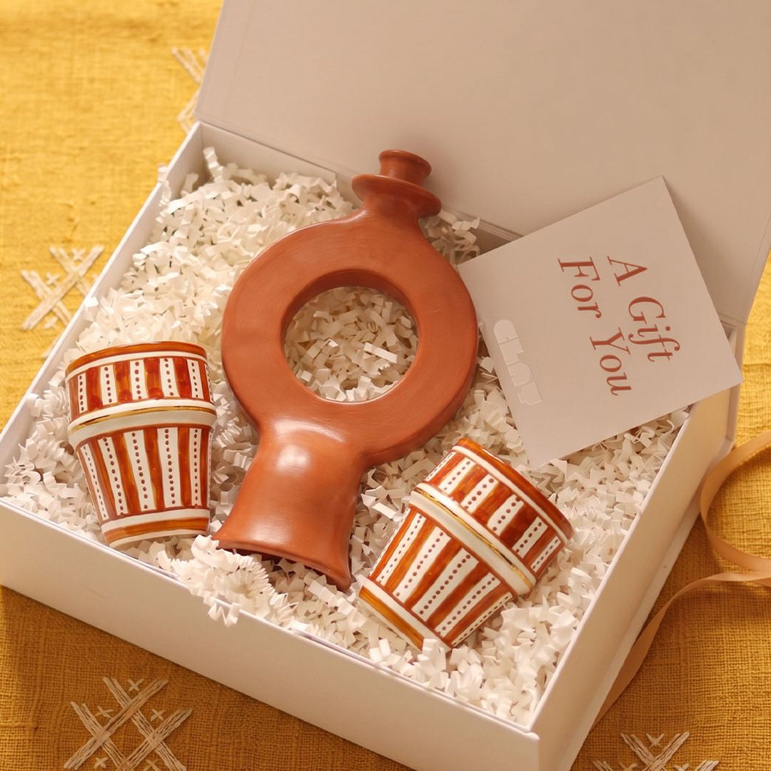 Decorative ceramic items in a gift box with a 'For You' card on a yellow textured background.