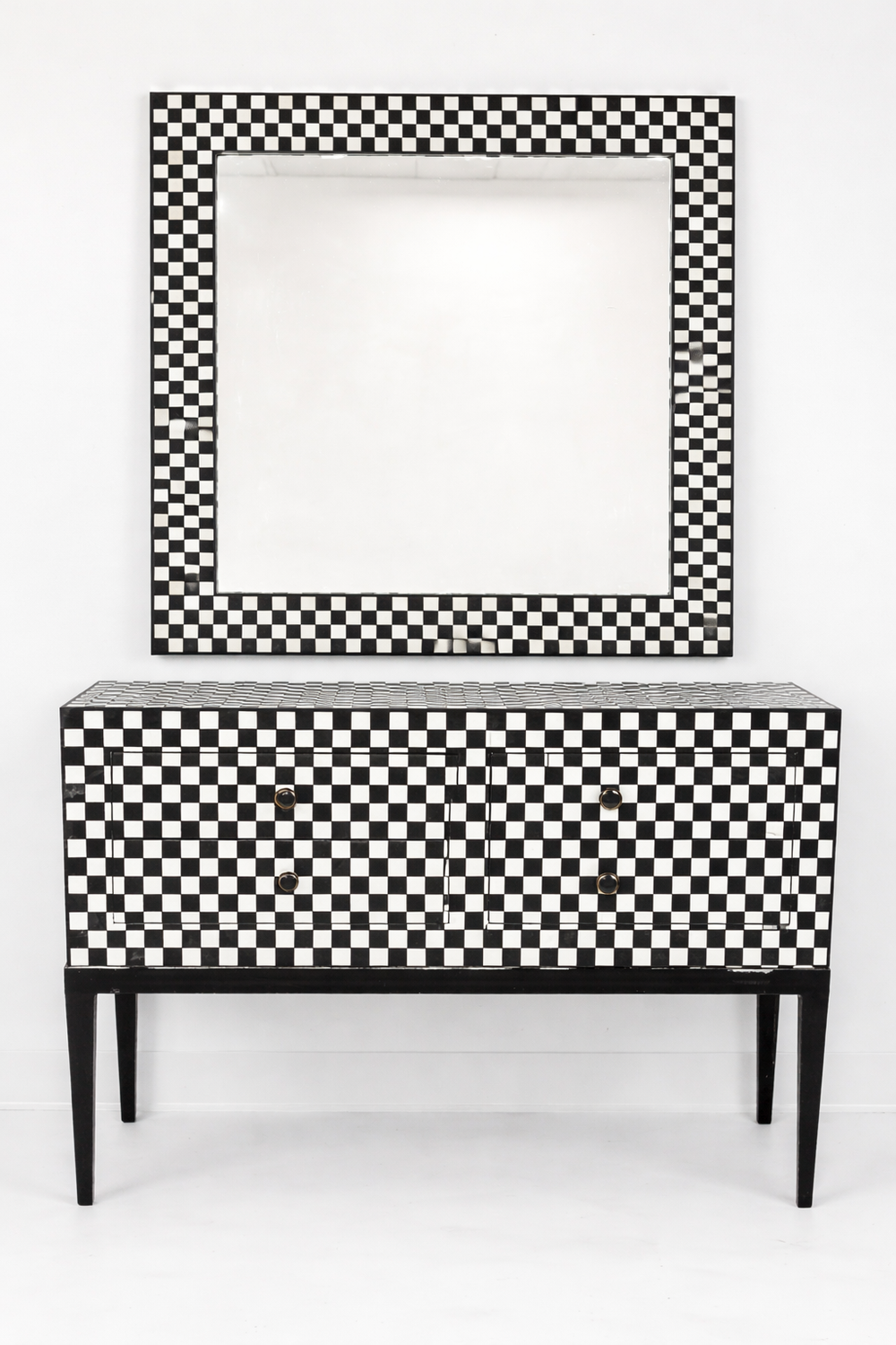 Black and white checkered cabinet with matching mirror on a white background