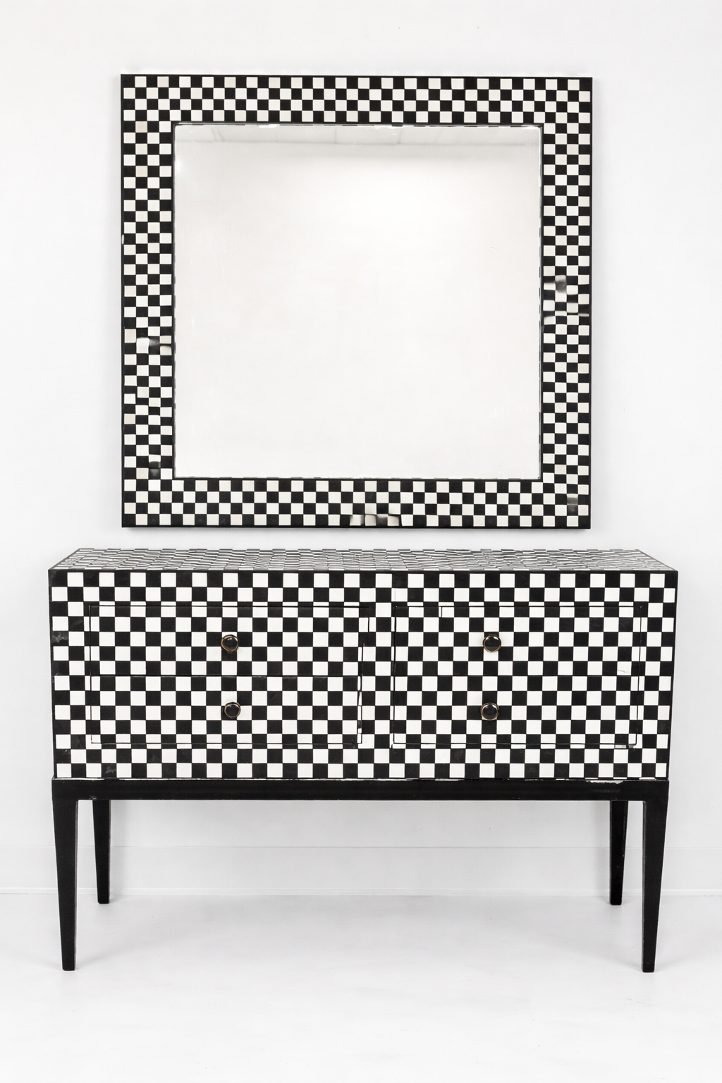 Black and white checkered cabinet with matching mirror on a white background