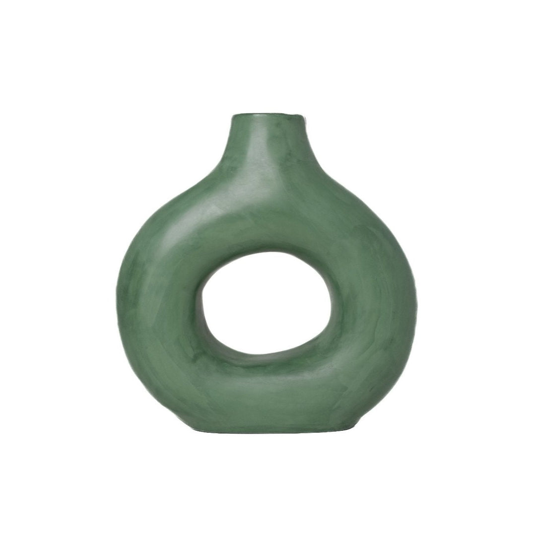 Unique handmade green ceramic vase with a round design. Handmade green ceramic vase with circular opening. Round green ceramic vase - contemporary decor piece