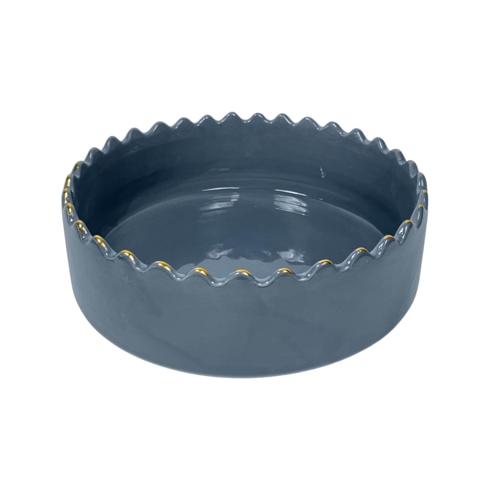 scalloped rim on handmade blue ceramic serving bowl