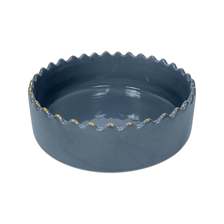 scalloped rim on handmade blue ceramic serving bowl