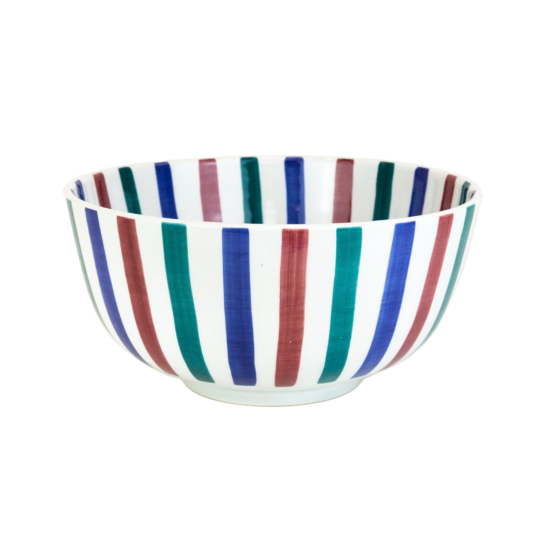 Ceramic bowl with multicolored stripes on a white background