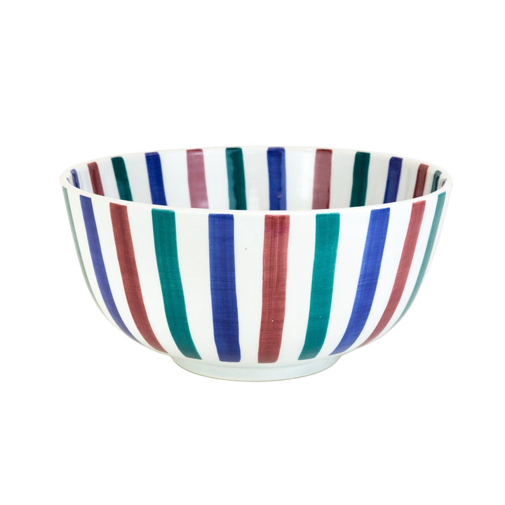 Ceramic bowl with multicolored stripes on a white background
